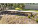 Long livestock barn with metal roof, wood fencing and gate enclosed near green grass and trees at 3360 Se 183Rd Avenue Rd, Ocklawaha, FL 32179