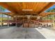 Covered parking area with access to the log home's porch, offering shelter and convenience at 3360 Se 183Rd Avenue Rd, Ocklawaha, FL 32179