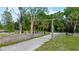Driveway leading to property with gate and mature trees lining the edge of the road at 3360 Se 183Rd Avenue Rd, Ocklawaha, FL 32179