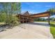 Charming log home with covered parking and porch, surrounded by lush greenery and a spacious driveway at 3360 Se 183Rd Avenue Rd, Ocklawaha, FL 32179