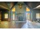 Log cabin living room with a stone fireplace and vaulted ceilings and wood flooring at 3360 Se 183Rd Avenue Rd, Ocklawaha, FL 32179