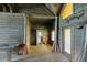 Hallway features log walls and wood plank floors with natural light and access to other rooms at 3360 Se 183Rd Avenue Rd, Ocklawaha, FL 32179