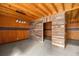 Basement with wooden accent wall, wood ceiling, hanging lights, brick accent and concrete floors at 3360 Se 183Rd Avenue Rd, Ocklawaha, FL 32179