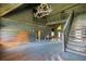 Spacious log cabin living room with a staircase leading to a loft area and wood flooring at 3360 Se 183Rd Avenue Rd, Ocklawaha, FL 32179