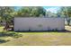 View of the side of the warehouse building and wooden staircase leading to a platform at 3360 Se 183Rd Avenue Rd, Ocklawaha, FL 32179