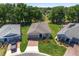 An elevated view of a landscaped home with well-manicured lawns and mature trees at 4306 Nw 54Th Ter, Ocala, FL 34482