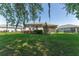 Lush backyard featuring well-manicured lawn and charming landscaping at 4306 Nw 54Th Ter, Ocala, FL 34482
