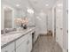 Bright bathroom with double vanity, granite counters, walk-in shower, and wood-look tile at 4306 Nw 54Th Ter, Ocala, FL 34482