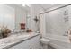 Bright bathroom features a granite vanity top, modern fixtures, and a tiled shower-over-tub with curtain at 4306 Nw 54Th Ter, Ocala, FL 34482