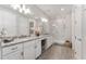 Bright bathroom with double vanity, granite counters, walk-in shower, and wood-look tile at 4306 Nw 54Th Ter, Ocala, FL 34482