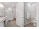 Bright bathroom with double vanity, granite counters, walk-in shower, and wood-look tile at 4306 Nw 54Th Ter, Ocala, FL 34482