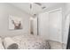 Cozy bedroom with light walls, closet, ceiling fan, and warm wood look tile at 4306 Nw 54Th Ter, Ocala, FL 34482
