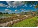 The community clubhouse has large outdoor seating area overlooking a pond and golf course with lush greenery at 4306 Nw 54Th Ter, Ocala, FL 34482