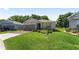 Inviting single-story home with a two-car garage, brick driveway, and lush green lawn at 4306 Nw 54Th Ter, Ocala, FL 34482