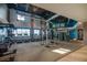 Well-equipped gym featuring modern cardio machines and weight training equipment, bathed in natural light from large windows at 4306 Nw 54Th Ter, Ocala, FL 34482