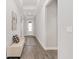 Bright hallway featuring a decorative ceiling, wood-look tile flooring, a bench, and art at 4306 Nw 54Th Ter, Ocala, FL 34482