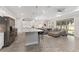 Modern kitchen featuring stainless appliances, a large granite island, and access to the living area at 4306 Nw 54Th Ter, Ocala, FL 34482