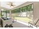 Relaxing screened-in lanai featuring comfortable seating and serene views of the backyard at 4306 Nw 54Th Ter, Ocala, FL 34482