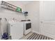 A functional laundry room with modern washer, dryer, built-in shelving, and decorative rug at 4306 Nw 54Th Ter, Ocala, FL 34482
