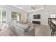 Spacious living room with coffered ceilings, wood floors and sliding glass doors to the outdoor living space at 4306 Nw 54Th Ter, Ocala, FL 34482