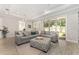 Spacious living room with a large sectional sofa, neutral decor, and easy access to the outdoor area at 4306 Nw 54Th Ter, Ocala, FL 34482