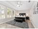 Calm bedroom with tray ceilings, plantation shutters and a comfortable sitting area at 4306 Nw 54Th Ter, Ocala, FL 34482