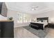 Serene bedroom featuring a tray ceiling, plantation shutters and a sitting area at 4306 Nw 54Th Ter, Ocala, FL 34482