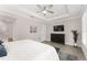 Stylish bedroom with tray ceilings, TV and views into en suite bath at 4306 Nw 54Th Ter, Ocala, FL 34482