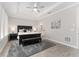 Relaxing bedroom featuring tray ceilings, plantation shutters, comfortable seating area and views of the en suite bath at 4306 Nw 54Th Ter, Ocala, FL 34482