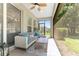 Inviting screened patio with a comfortable sectional, stylish rug, and a view of the outdoor landscape at 4306 Nw 54Th Ter, Ocala, FL 34482