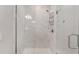Walk-in shower featuring marble-look tile, rainfall shower head, and glass enclosure at 4306 Nw 54Th Ter, Ocala, FL 34482