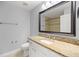 Bathroom with granite countertop, large mirror, toilet, and tub-shower combo at 4324 Sw 98Th Ln, Ocala, FL 34476