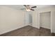 Bedroom with hardwood floors, ceiling fan, closet, and entry to the bathroom at 4324 Sw 98Th Ln, Ocala, FL 34476