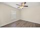 Bedroom featuring hardwood floors, a ceiling fan, and a bright window at 4324 Sw 98Th Ln, Ocala, FL 34476