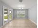 Light-filled dining area with neutral walls, and backyard access, creates a serene setting for Gathering meals at 4324 Sw 98Th Ln, Ocala, FL 34476