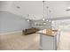 Well-lit kitchen island with pendant lighting and granite countertops provides ample space for meal preparation and casual dining at 4324 Sw 98Th Ln, Ocala, FL 34476