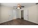 Primary bedroom features wood floors, ceiling fan, closet, and ensuite bathroom access at 4324 Sw 98Th Ln, Ocala, FL 34476