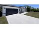Long driveway to a single-Gathering home with a spacious garage and tidy front lawn at 455 Marion Oaks Dr, Ocala, FL 34473