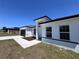 Home exterior featuring clean white stucco, black trim, and simple, well-maintained landscaping at 455 Marion Oaks Dr, Ocala, FL 34473