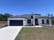 Charming single Gathering home with modern design elements, large garage, and freshly installed landscaping at 455 Marion Oaks Dr, Ocala, FL 34473