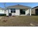 Wide backyard with a covered patio, perfect for outdoor entertaining and relaxation at 5077 Stokes Way, Wildwood, FL 34785
