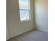 Cozy bedroom with soft carpet and a window providing natural light and neighborhood views at 5077 Stokes Way, Wildwood, FL 34785