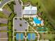 Aerial top-down of the community amenities: pool, tennis courts, bocce ball, clubhouse and parking at 5220 Sunshine Dr, Wildwood, FL 34785