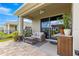 Cozy covered back patio featuring comfortable seating and outdoor serving area at 5220 Sunshine Dr, Wildwood, FL 34785