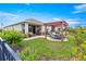 Beautiful backyard patio with pergola, landscaping, and outdoor seating for entertaining at 5220 Sunshine Dr, Wildwood, FL 34785