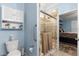 Bathroom features a tiled glass shower, toilet, and ample storage space at 5220 Sunshine Dr, Wildwood, FL 34785