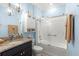 Bright bathroom features a tub and shower with a glass enclosure and vanity at 5220 Sunshine Dr, Wildwood, FL 34785
