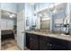 Bathroom with double vanity, granite countertop, and direct bedroom access at 5220 Sunshine Dr, Wildwood, FL 34785
