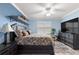Well-lit bedroom featuring a dark wood bed frame and a large television at 5220 Sunshine Dr, Wildwood, FL 34785