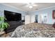 Large bedroom with ensuite bathroom, a dark dresser, and ample natural light at 5220 Sunshine Dr, Wildwood, FL 34785